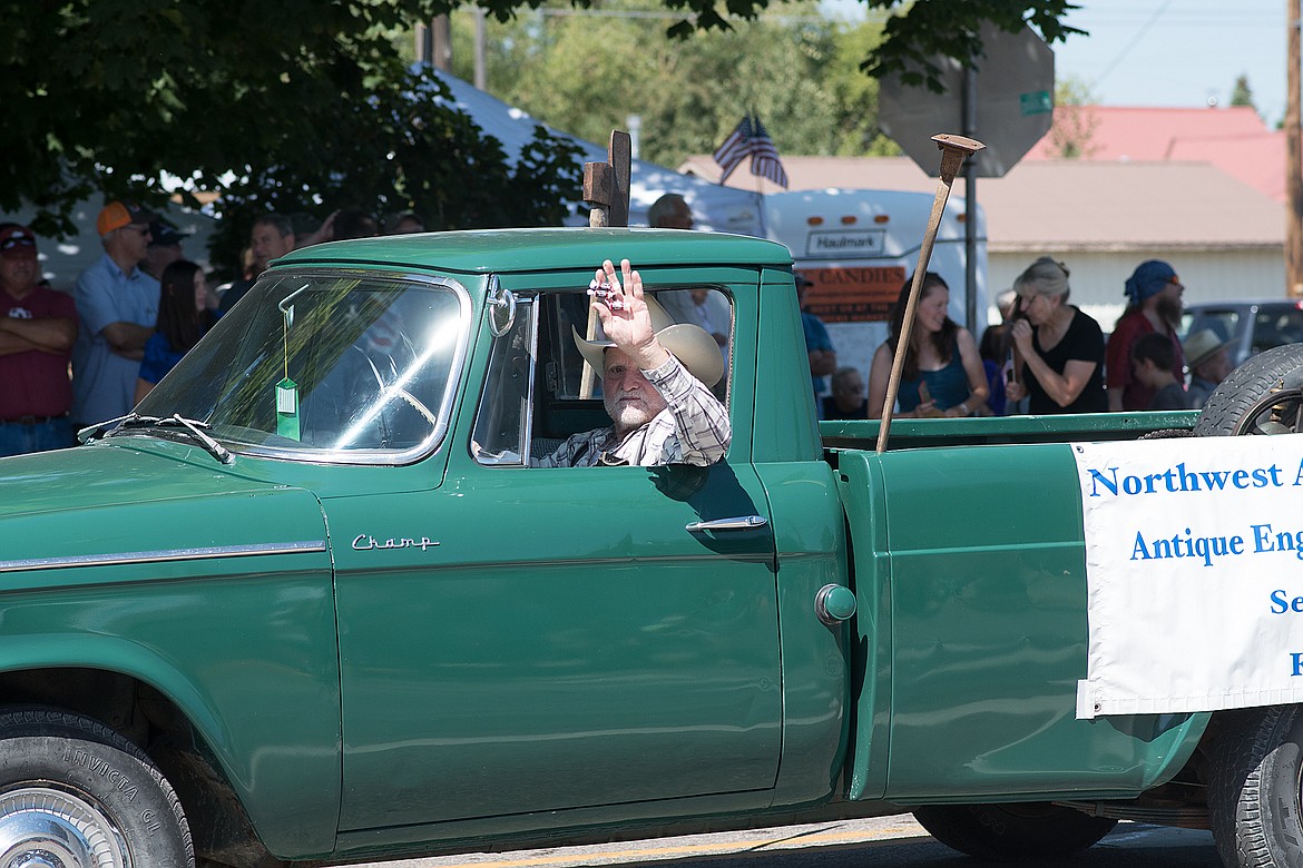 Tex Manus throws candy out to the kids.