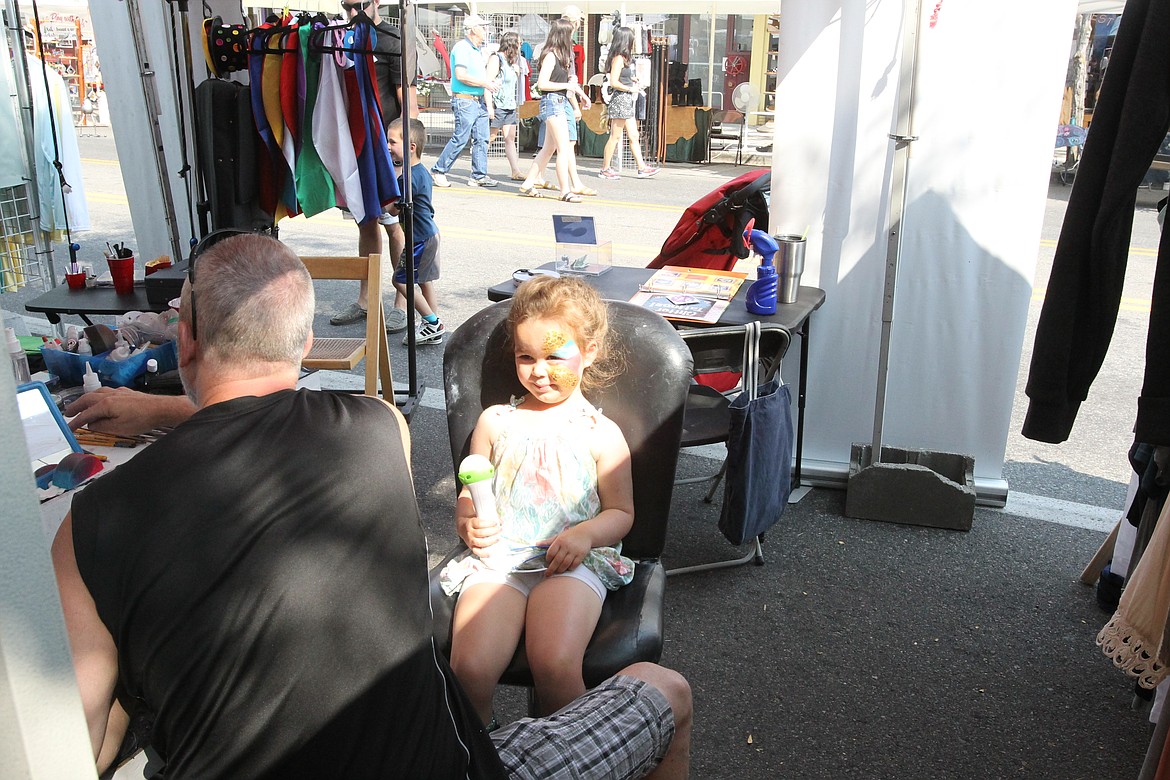 MITCHELL BONDS/Press
Sophie Smee gets her face painted by Todd Rima, co-owner of People Painters, at the Downtown Association&#146;s Street Fair on Sunday. &#147;We were just talking about how it&#146;s been so nice this summer without all the smoke, and now this,&#148; said Sophie&#146;s mother, Jamie.