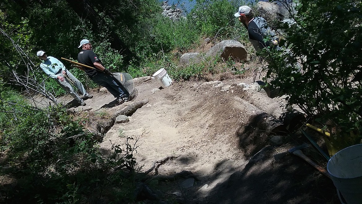 From left, Rusty Baillie, John Bowman and Shane Myr discuss the next step in rebuilding a section of the Shoreline Trail at Farragut State Park.