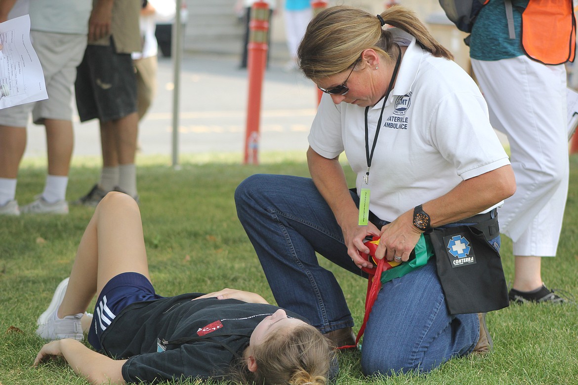 Richard Byrd/Columbia Basin Herald
An EMT assesses a patient&#146;s status during Tuesday&#146;s simulation.