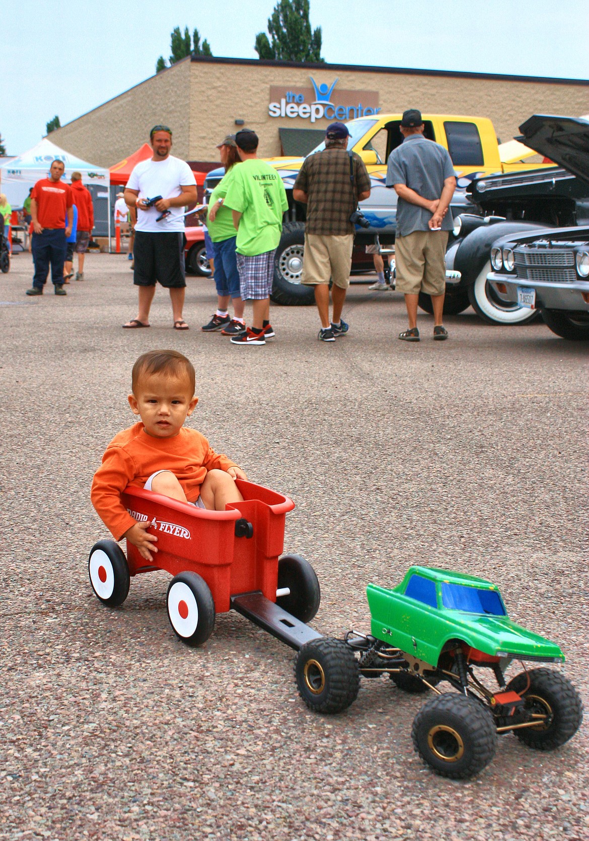 Lil' guy Luke Nice (14 months old) is pulled around by a remote control truck while his Father Morgan Nice controls the truck via remote. (Patrick Booth/Mystic Creek Studios)