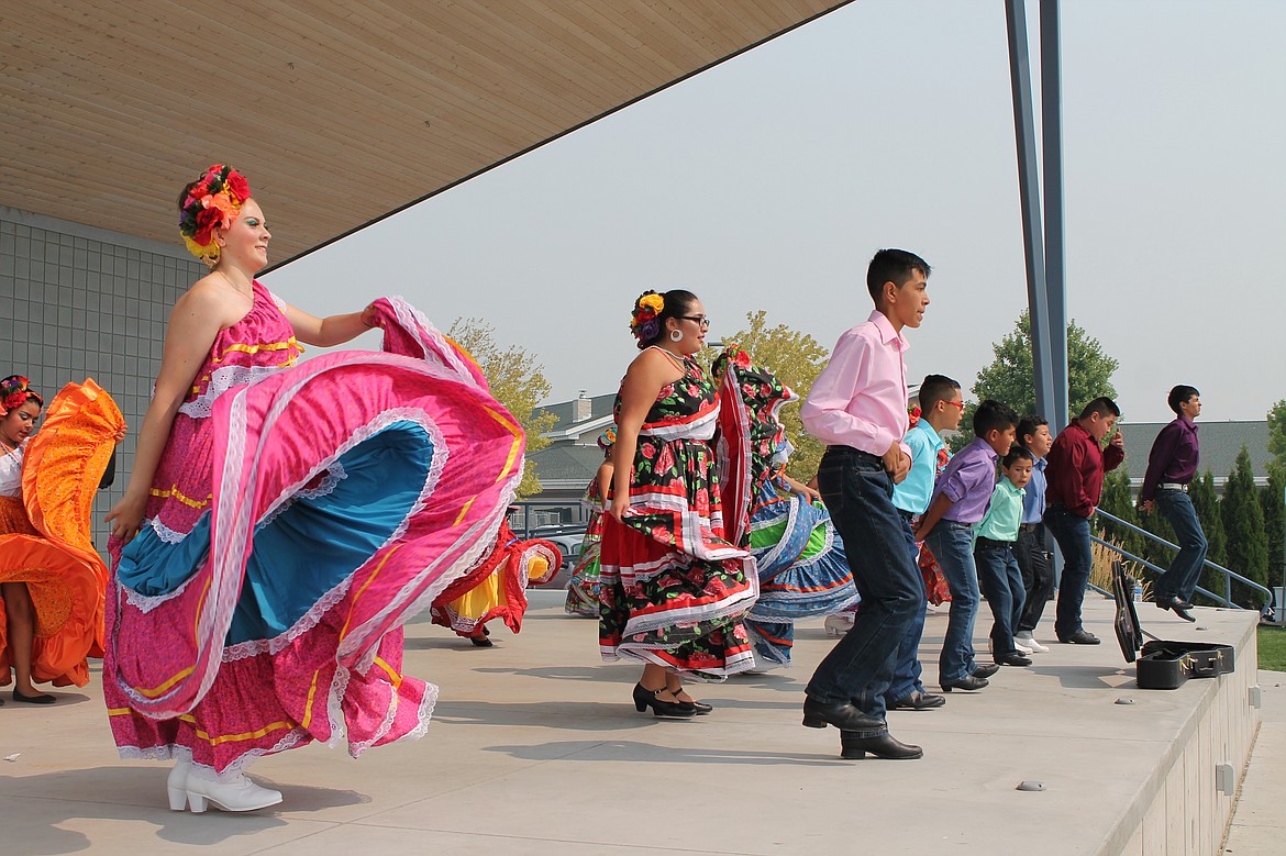 Charles H. Featherstone/Columbia Basin Herald
Members of Sol y Luna, a youth group which practices traditional Mexican folk dance, perform during the Quincy Farmers Market on Saturday.