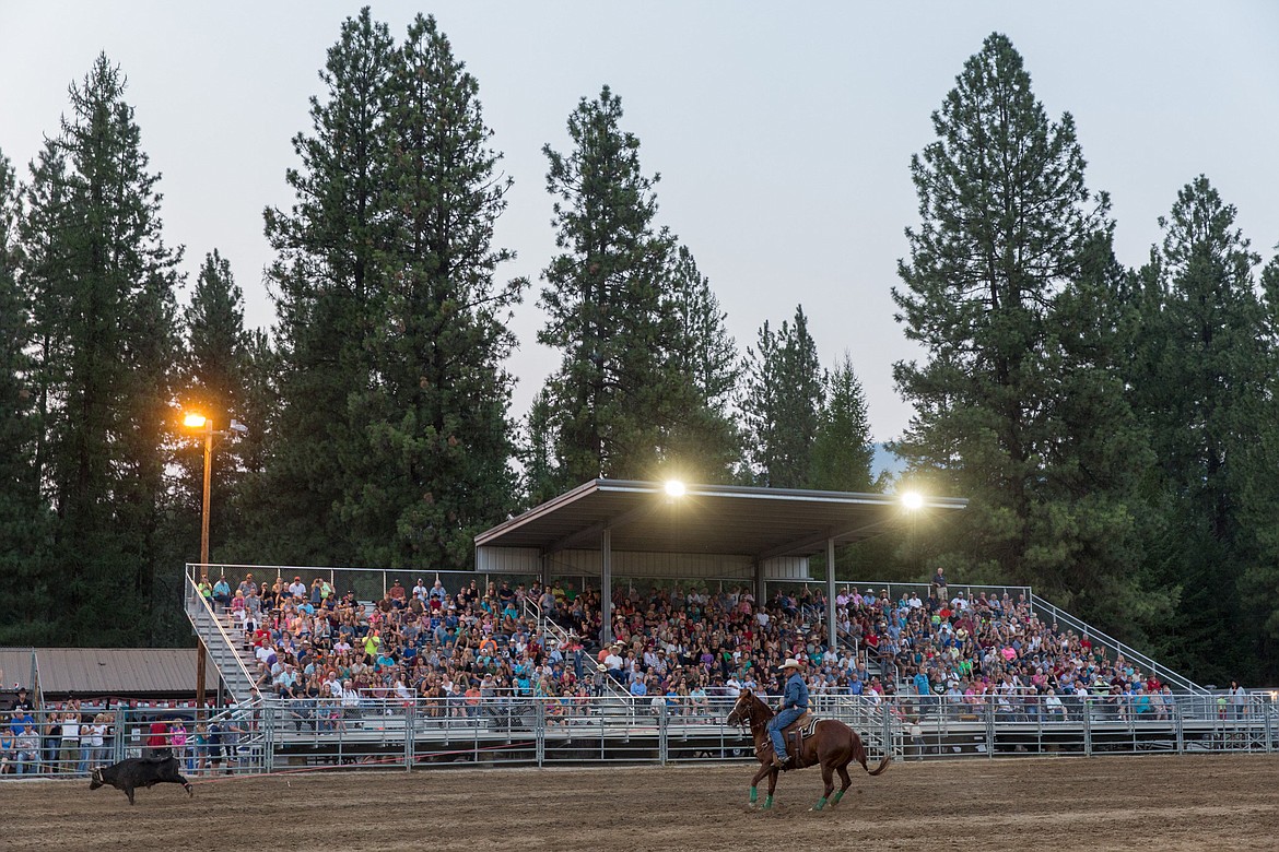 Spectators watch calf roping at the Kootenai River Stampede PRCA Rodeo in Libby Saturday, Aug. 5. (John Blodgett/The Western News)