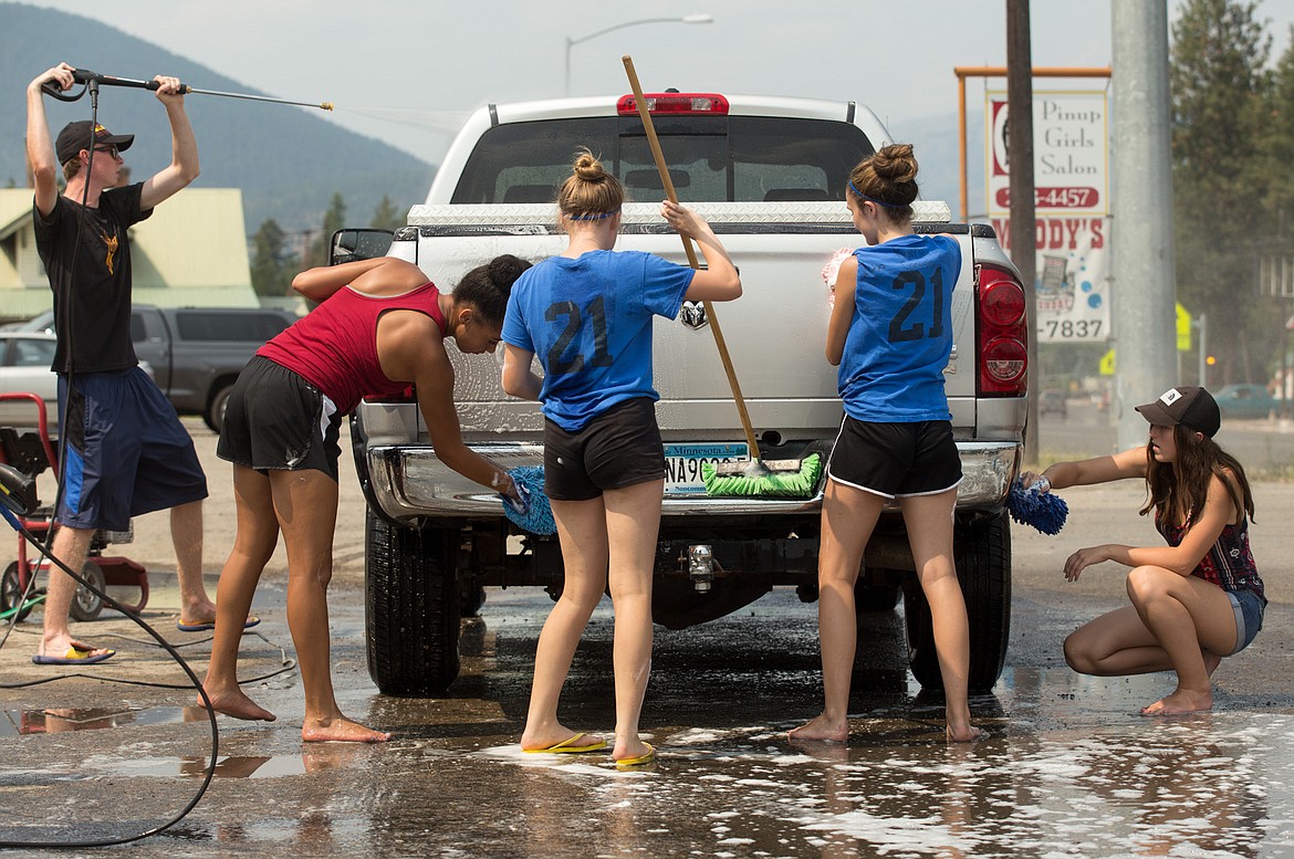 The Libby High School volleyball team holds a fundraising car wash in front of Carquest Car Parts in Libby Saturday, Aug. 5, 2017. (John Blodgett/The Western News)