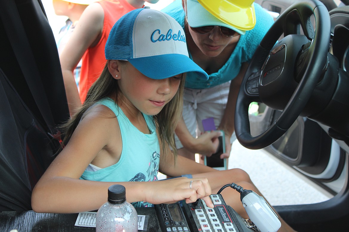 Among all the things to do, one of the most popular activities was running the siren on the police car.