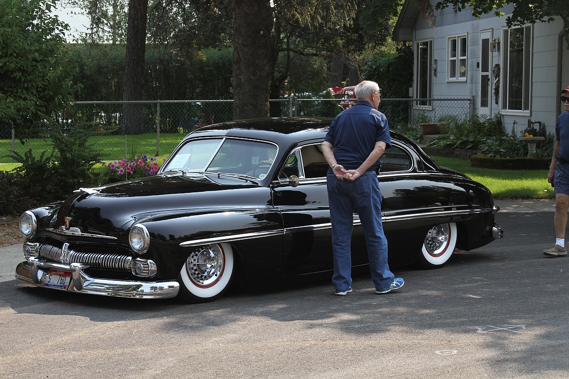 A spectator looks over this 1950 Mercury.