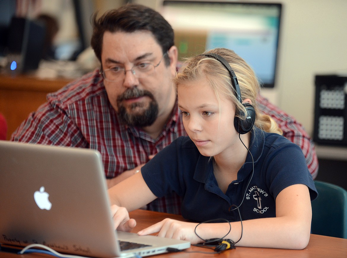 Darren Fix, a programer with Flathead Electric, works with Madison Hammett, a sixth grader at St. Matthew&#146;s School during the Hour of Code on Thursday, December 12, 2013 in Kalispell. St. Matthew&#146;s was voted the Best Place Private School in the 2017 Best of the Flathead Poll.
(Brenda Ahearn/Daily Inter Lake)