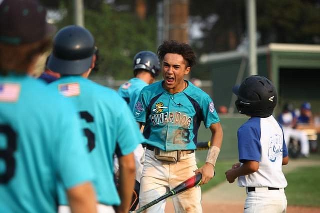 Rodney Harwood/Columbia Basin Herald - Moses Lake shortstop Cody Alvarado reacts after scoring during Monday's 10-0 victory over Blue Lick from Louisville, KY. The River Dogs improved to 2-1 in pool play.