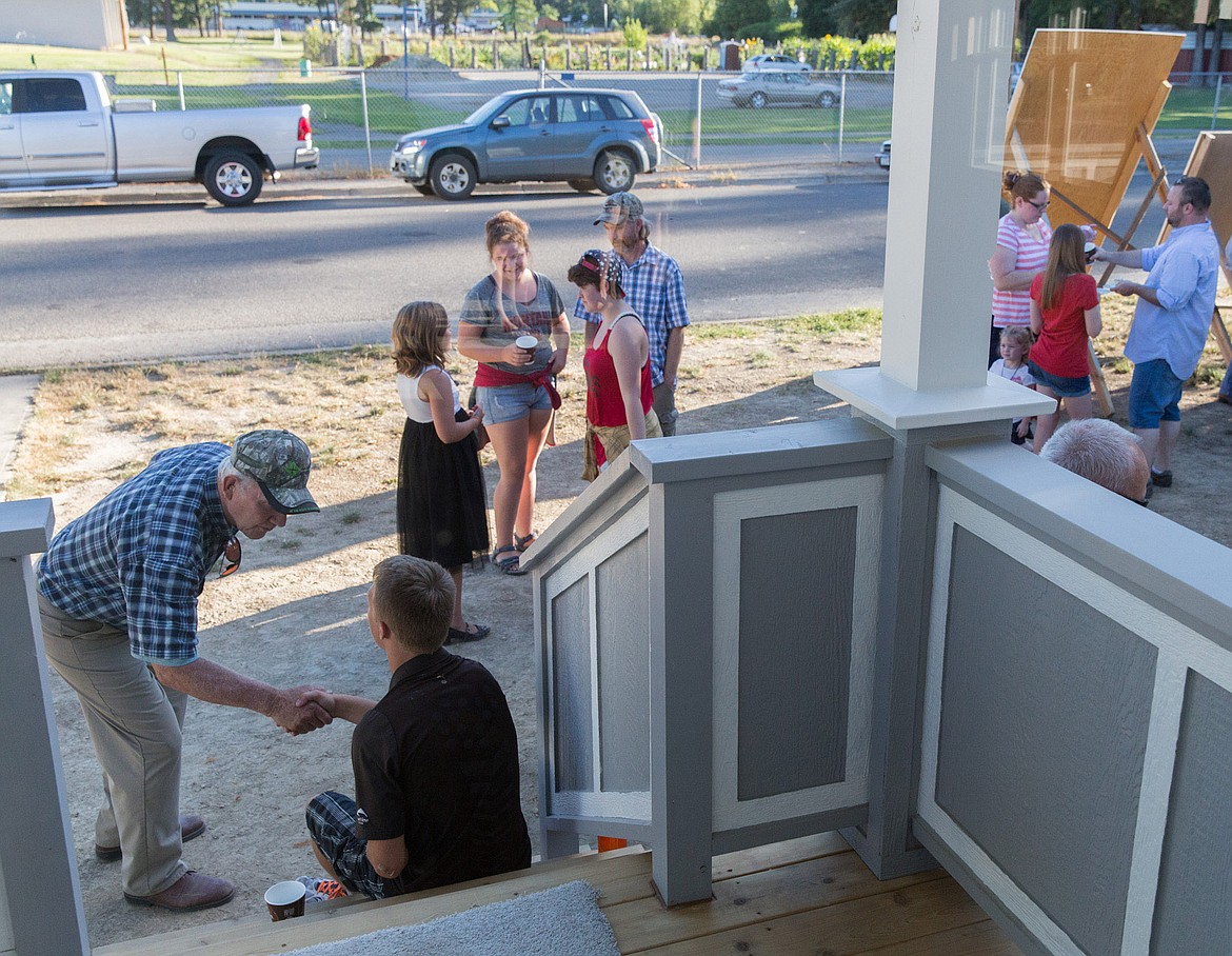 Neighbors, friends and family gather at Norma Sweet's new Habitat for Humanity home Sunday evening in Libby. See story on Page 1. (John Blodgett/The Western News)