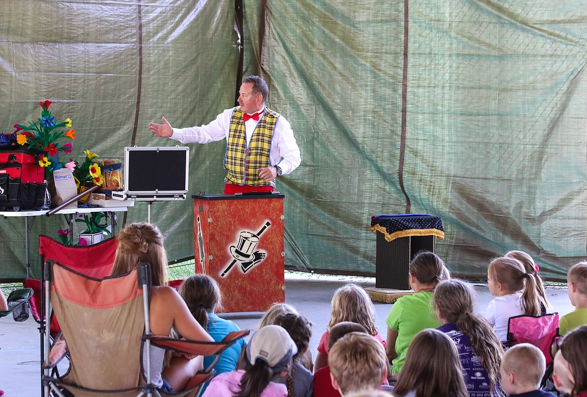 Photo by Mandi Bateman
Children eagerly hoped to be chosen by award winning illusionist and comedian, Dave the Magic Man, to participate in his performance at the Boundary County Fairgrounds on Wednesday, July 26. The show, &#147;Build a Better World,&#148; was the bookend of the Boundary County Library&#146;s Summer Reading program. Dave the Magic Man, from Bonners Ferry, delighted the crowd with magic tricks, humor, and audience participation.