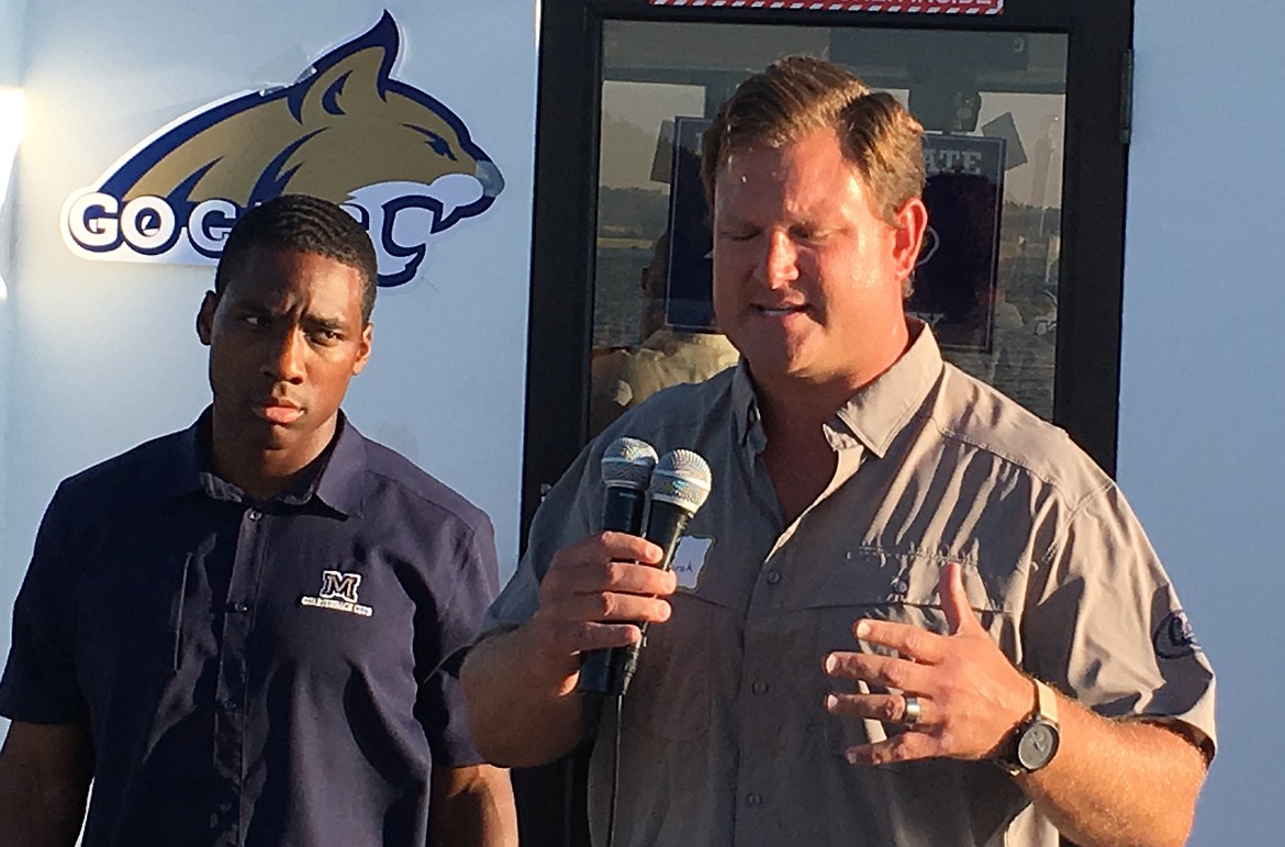 FORMER MONTANA State Bobcat standout quarterback Denarius McGhee (left) and defensive coordinator Tyler Gregorak speak at the Bobcat boatride Friday night on the Shadow boatride at the KwaTaqNuk Resort. (Photo courtesy of Tom Farrell)