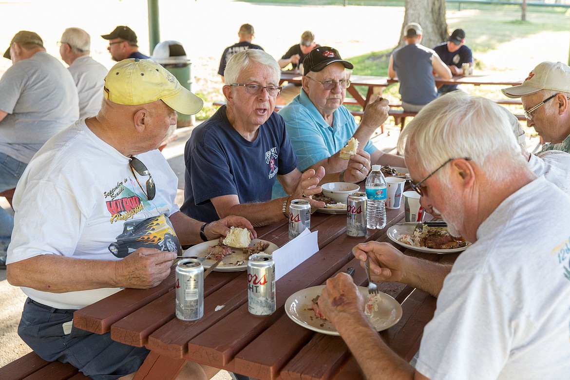 Retired firefighters attend the annual barbecue. They are from right to left: Dick Wood (yellow hat), Ken Preston, Dick Dutton and, on the&#160;other side of table, George Wood and Gary Swenson. (John Blodgett/The Western News)