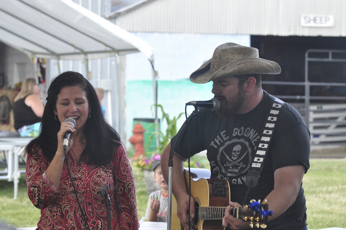 Cammy Maughan, left, and her son, Aaron Broxterman, sing after the Lake County Fair talent show, where Cammy won first place. (Ashley Fox/Lake County Leader)