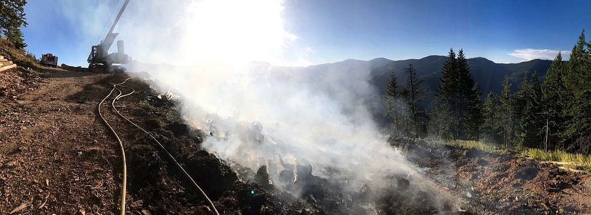 The aftermath as seen during the day. One of damaged logging machines can be seen in the distance.