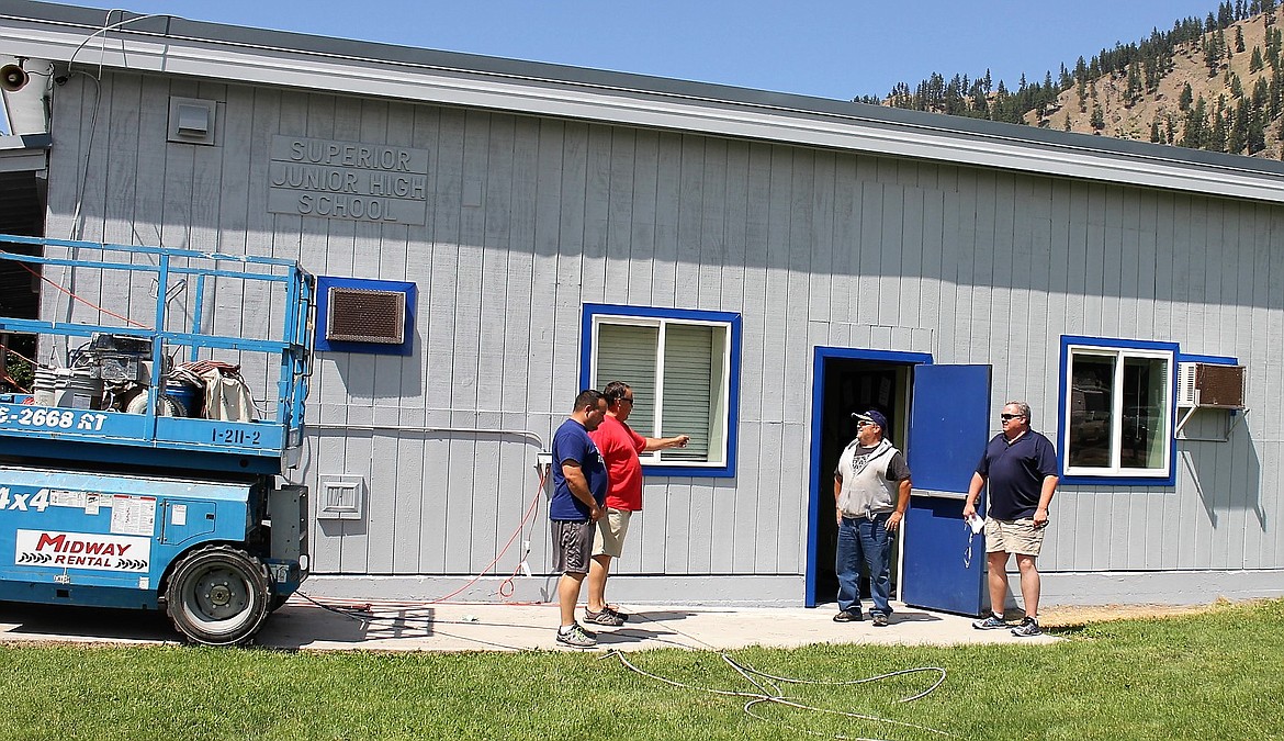 Superior High School Principal Chris Clairmont (left), retired principal Alan Labbe, maintenance manager Hugh Hopwood, and Superintendent Scott Kinney (right) discuss needed repairs for the junior high school. Repair and upkeep costs are estimated at $1.5 million. (Kathleen Woodford/Mineral Independent)