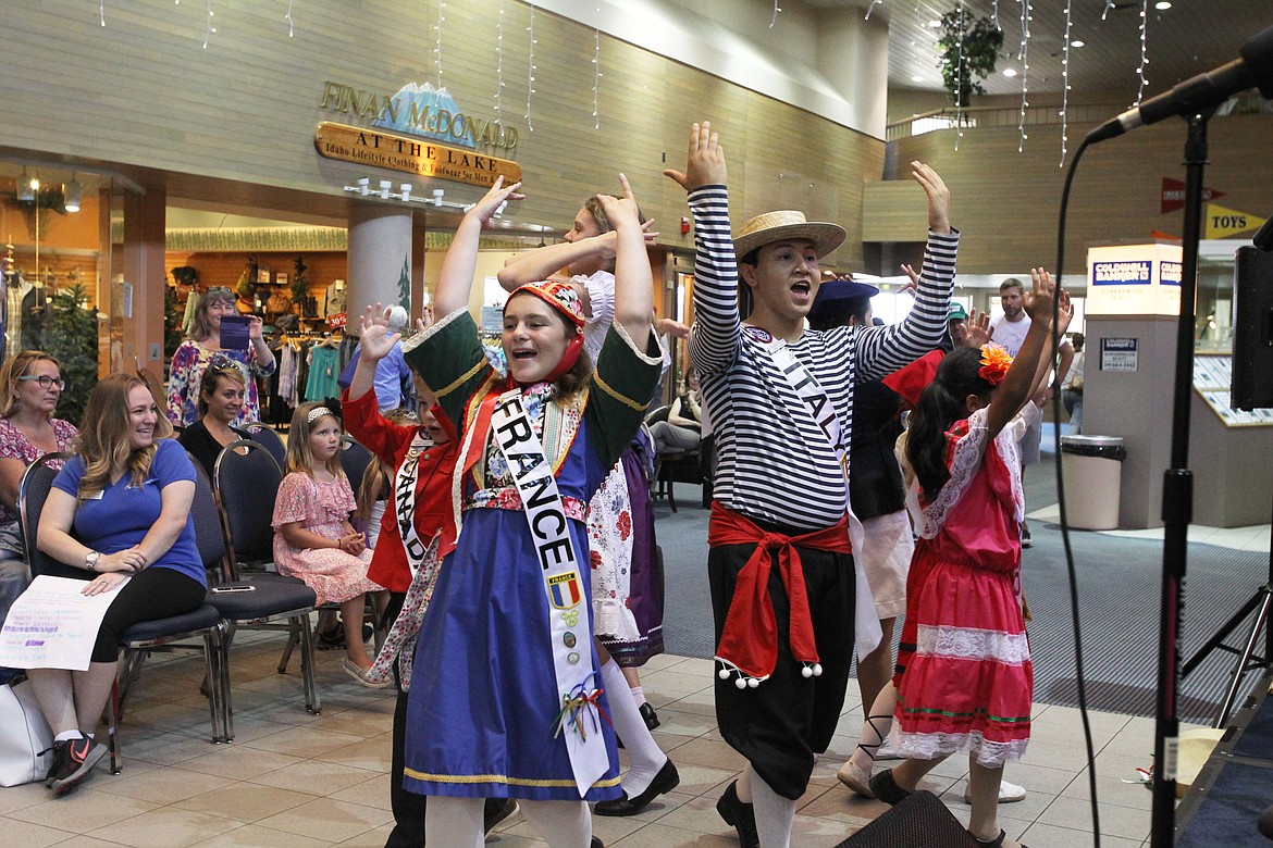 DEVIN HEILMAN/Press
Maia Cabanel-Bleuer, 12, &#147;France,&#148; and Dominic Collins, 18, &#147;Italy,&#148; dance the Israeli Hora with their International Peace Choir peers Thursday morning at The Coeur d&#146;Alene Resort Plaza Shops. The young performers deliver messages of world peace and hope through their songs while representing the diverse heritage of their families and America.