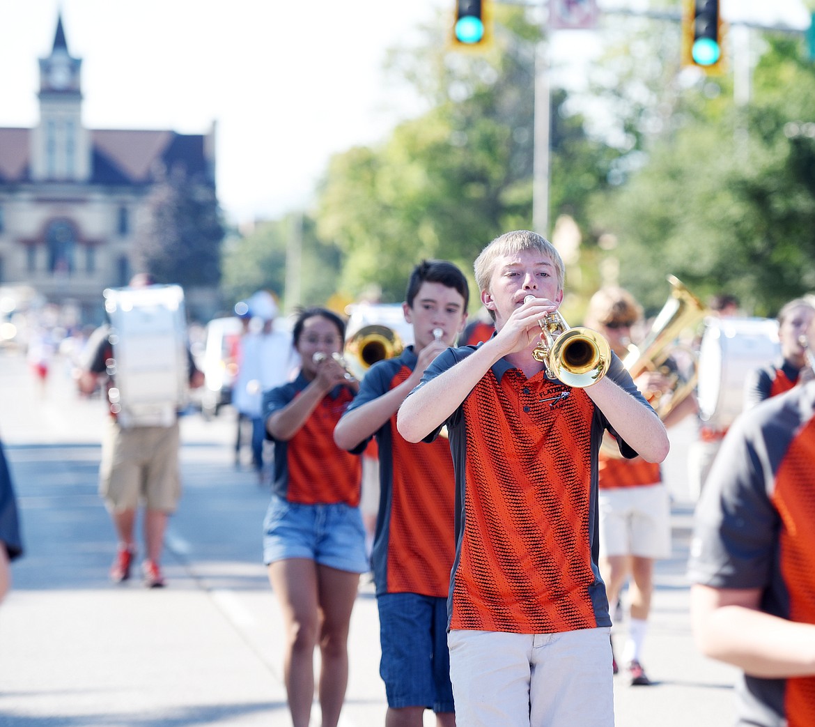 Flathead senior Matt Carroll and members of the Flathead High School Marching Band make their way down Main Street on Friday as they take part in the Northwest Montana Fair Parade in downtown Kalispell.