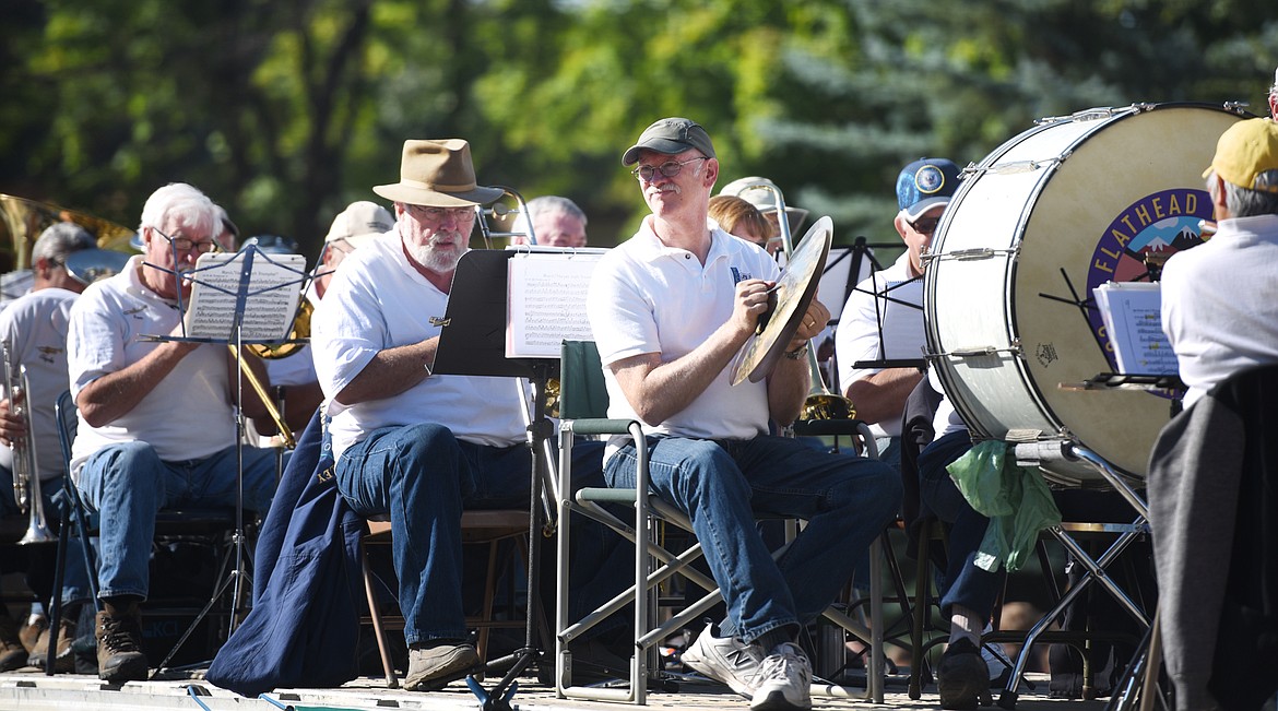 Allen Stater, the former band teacher at Flathead High School, helps out with the percussion section of the Flathead Valley Community Band float in the 2017 Northwest Montana Fair Parade on Friday morning, August 18, in downtown Kalispell.(Brenda Ahearn/Daily Inter Lake)