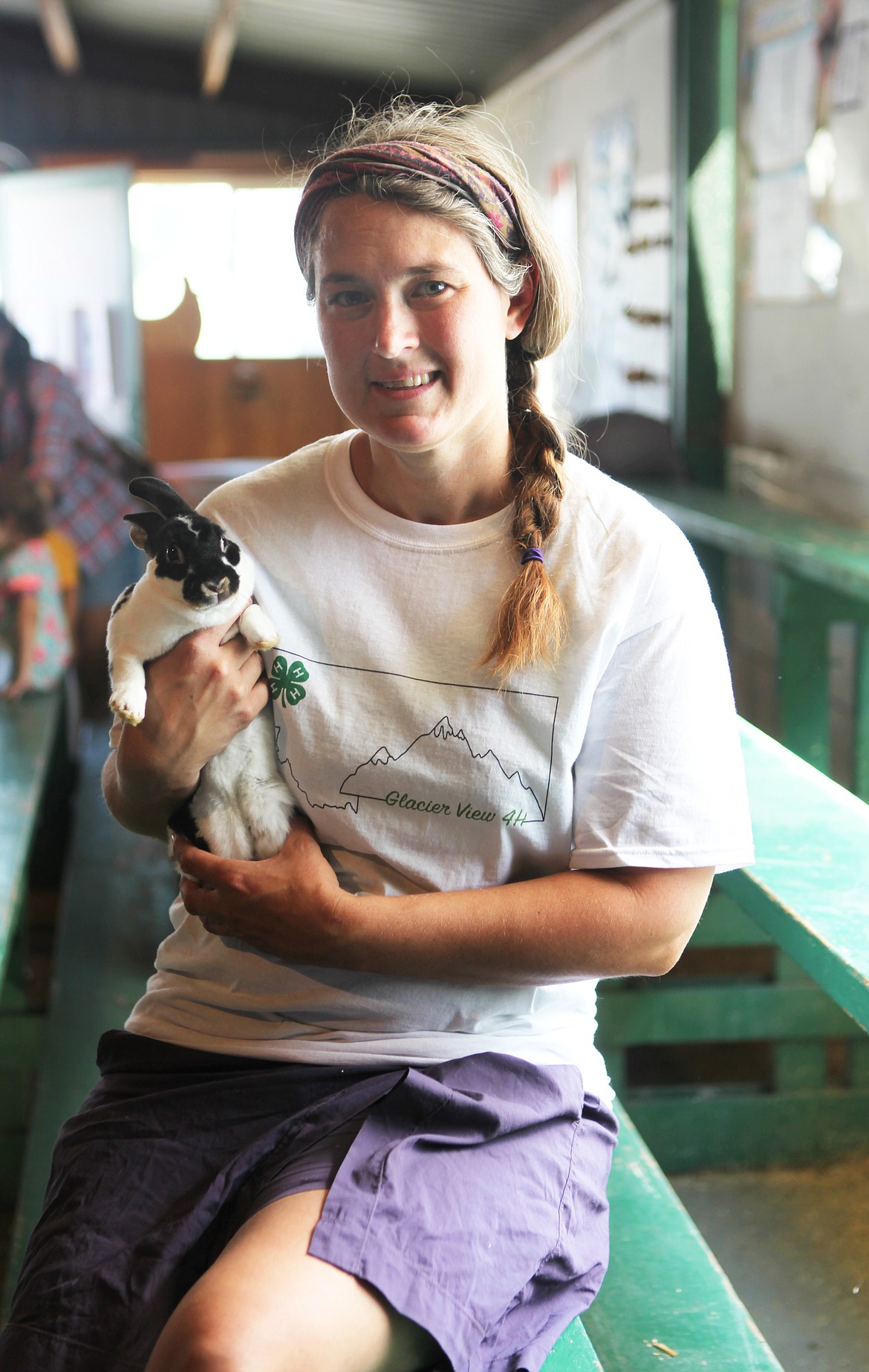 KellySue Bain holds a bunny inside the rabbit barn Thursday afternoon. Bain was instrumental in bringing the bunny jump competition to the fair this year and is planning to hold an additional contest in September. (Mackenzie Reiss/Daily Inter Lake)