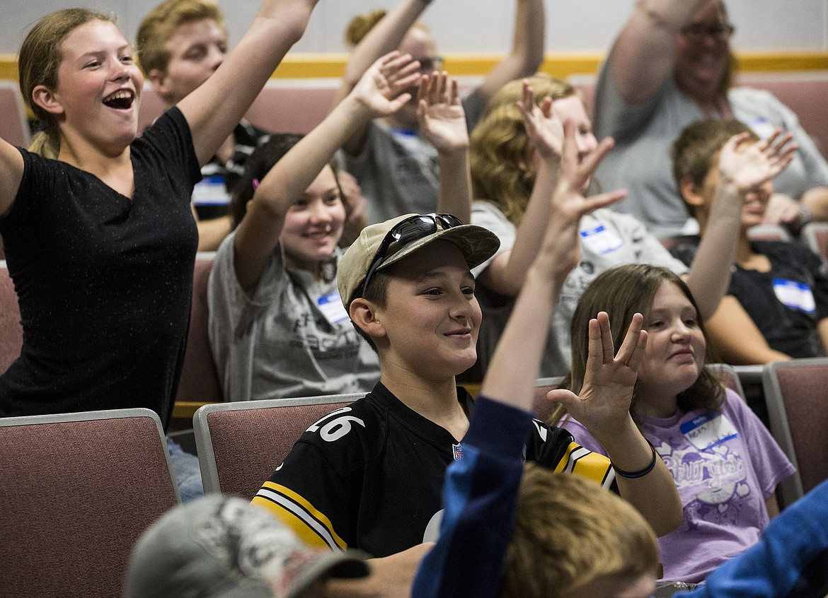 (LOREN BENOIT/Hagadone News Network)
Tyler Engelbrecht, 12, center, Vulcan salutes during a live broadcast gathering Friday morning at North Idaho College for the Zero Robotics Middle School Summer Program finals.