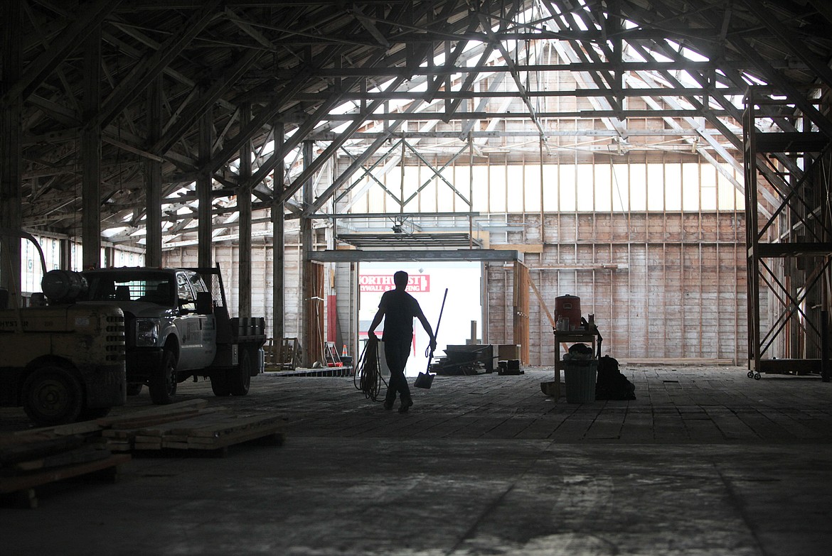 Heritage Timber owner Gary Delp carries supplies across the Wright&#146;s Kalispell Lumber building Thursday. (Mackenzie Reiss/Daily Inter Lake)