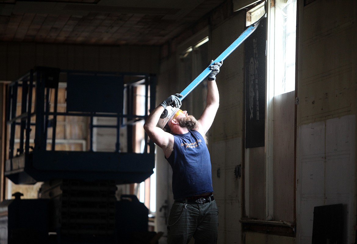 Cody Craig deconstructs the interior of the Wright&#146;s Kalispell Lumber building Thursday morning. (Mackenzie Reiss/ Daily Inter Lake)