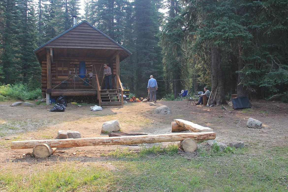 Photo By Tanna Yeoumans
A few members of the crew finishing cleaning up around the cabin. Pictured are the new benches around the fire pit and new staircase, among more subtle changes.