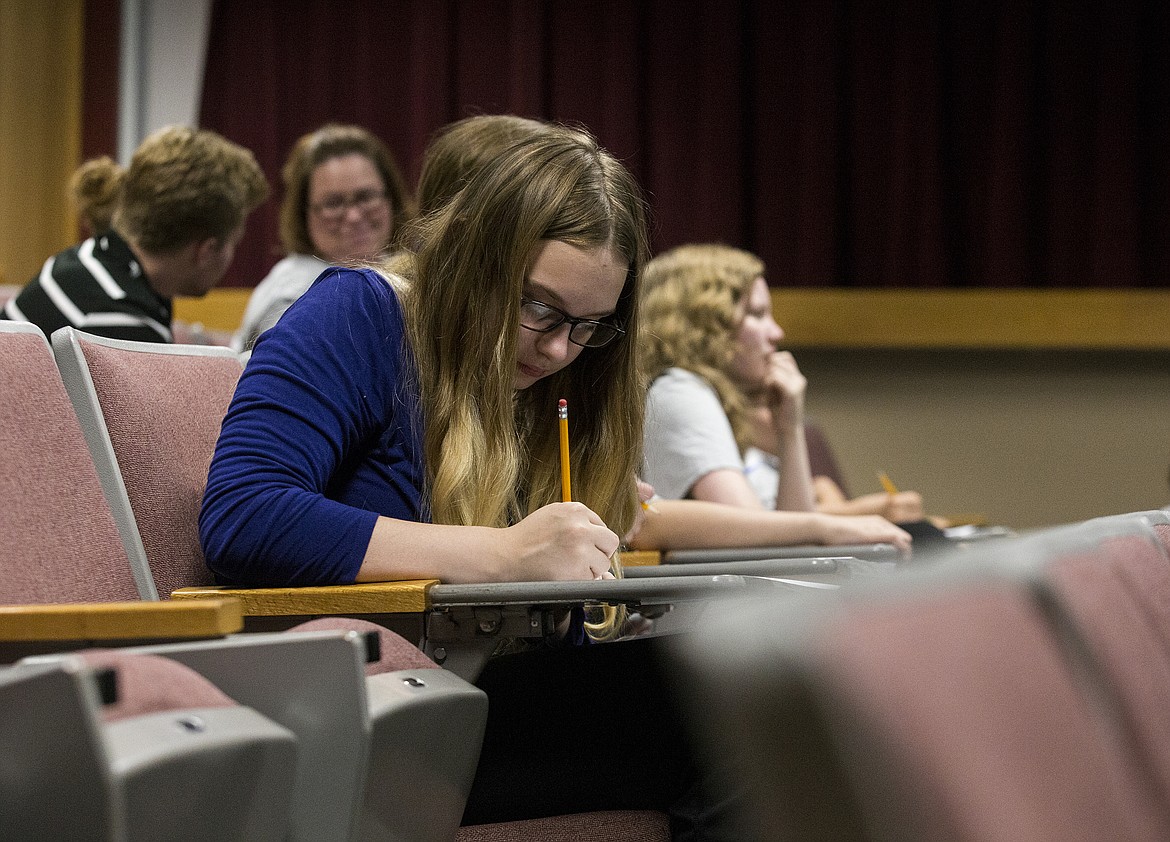 LOREN BENOIT/PressMacayla Hunter, 14, fills out her Zero Robotics International Space Station Finals score sheet Friday morning at North Idaho College.