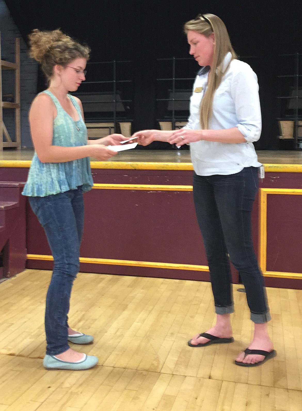 Molly Walters is awarded a check by Grete Gransauer of Montana Wilderness Association for her essay, “Falling for Falls Creek.” (Courtesy Photo)