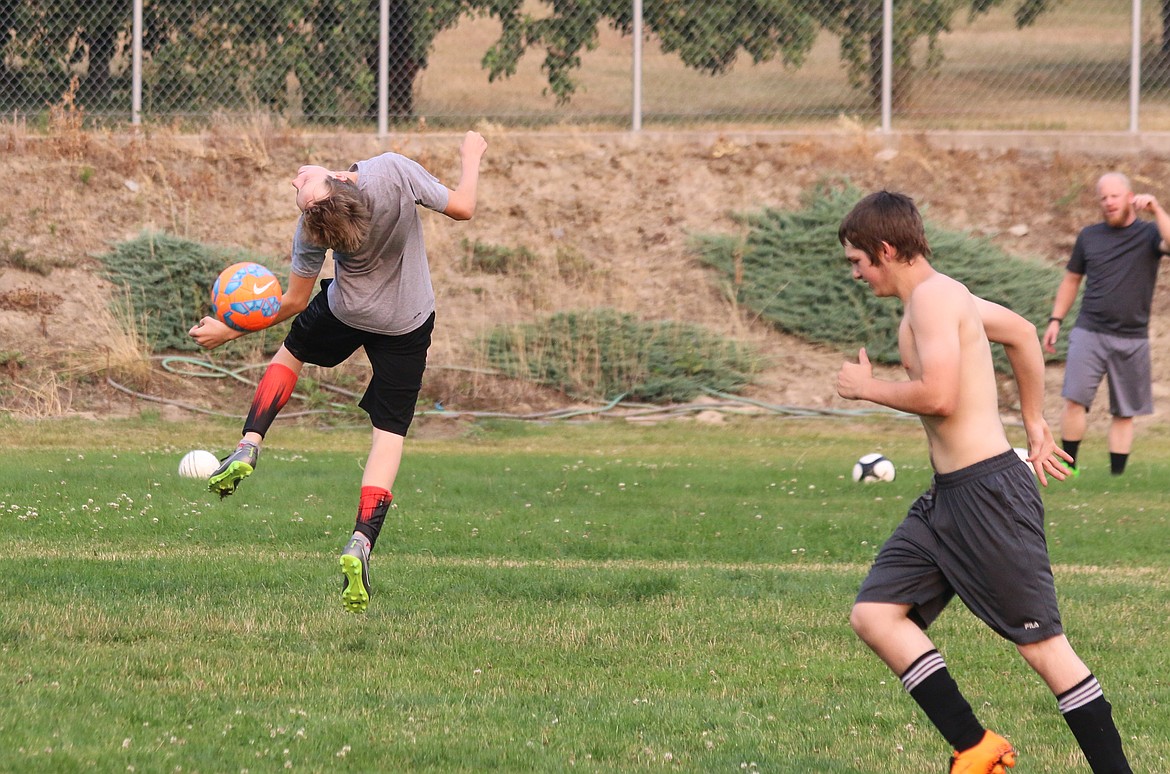 A soccer player bends over backward for the team and coach Wayne Wilkerson during a recent practice. The Bonners Ferry boys begin their season Saturday, hosting Priest River at 7 p.m.