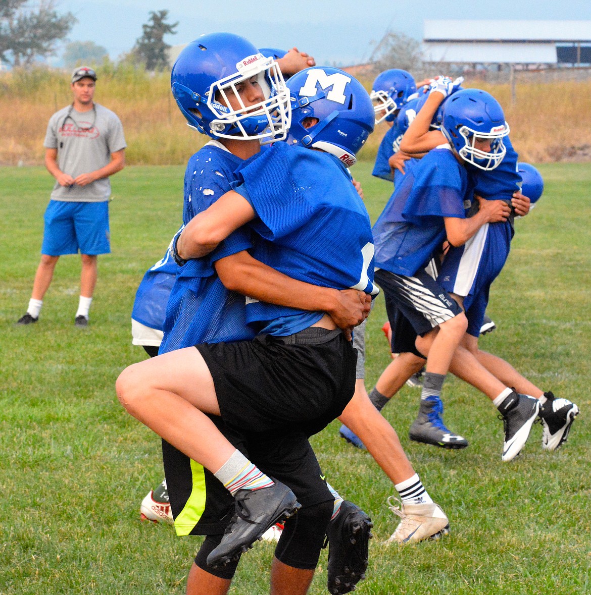 TWO MISSION High School fooball players go through practice drills Friday afternoon at Mission High School. The Bulldogs will transition from Class B, 11-man to Class C, 8-man football this season. With the change the Mission Bulldogs look to be more competitive with the turnout of 28 kids in Class C. A 28-man roster in 8-man is considered a large roster, according to several area 8-man coaches. (Jason Blasco/Lake County Leader)