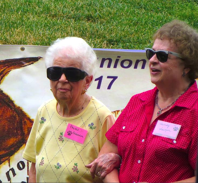 KHS All-Class Grand Marshall Phyllis Williams is escorted to the stage by her daughter Sandy Martin. Williams graduated from Kellogg High School in 1934.