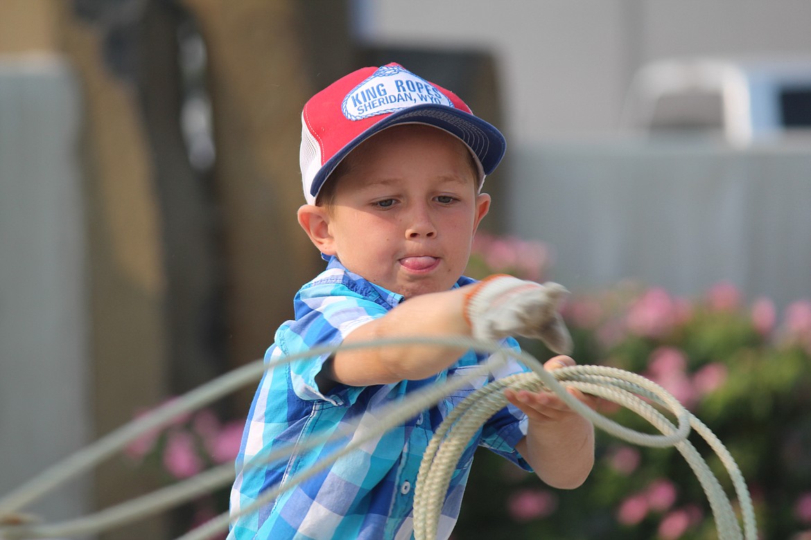 Cheryl Schweizer/Columbia Basin Herald
Colt Staples gives it his all in the roping contest at the Cowboy Breakfast Friday.