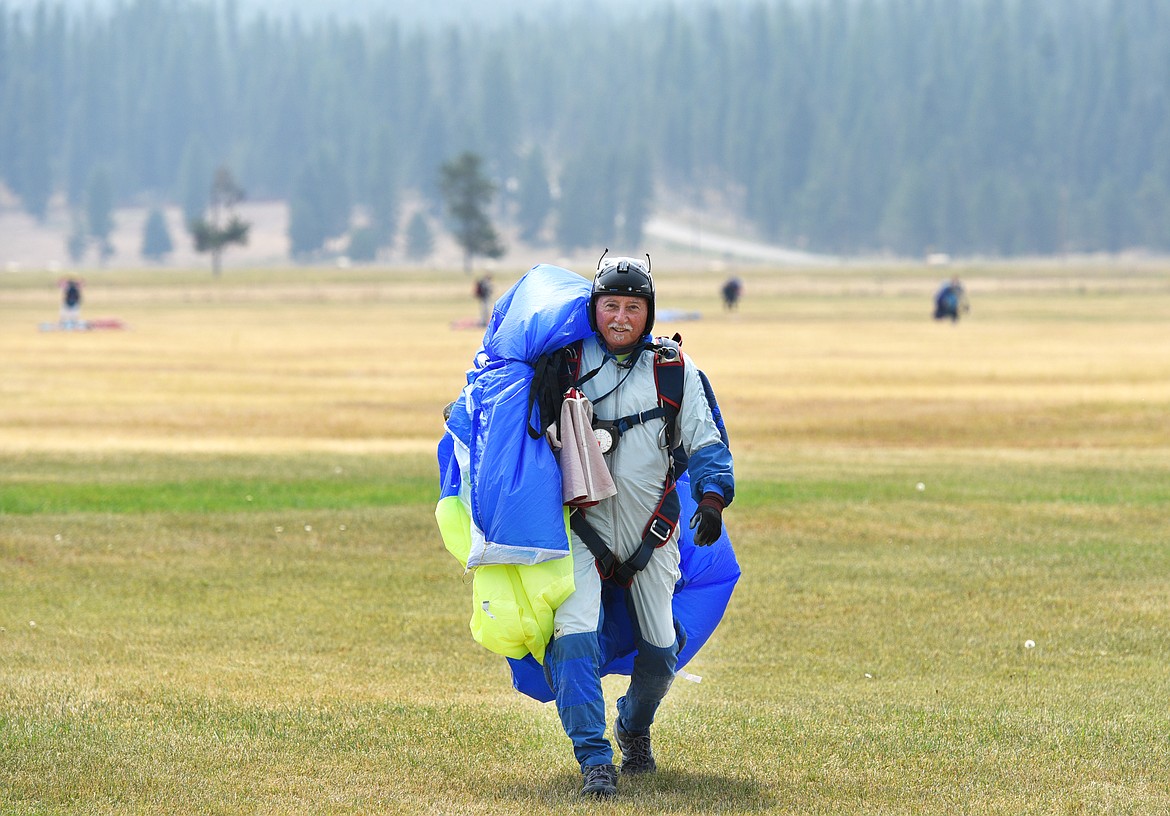 Dick Rapacilo walks back to his camp after skydiving on Thursday. (Aaric Bryan/Daily Inter Lake)