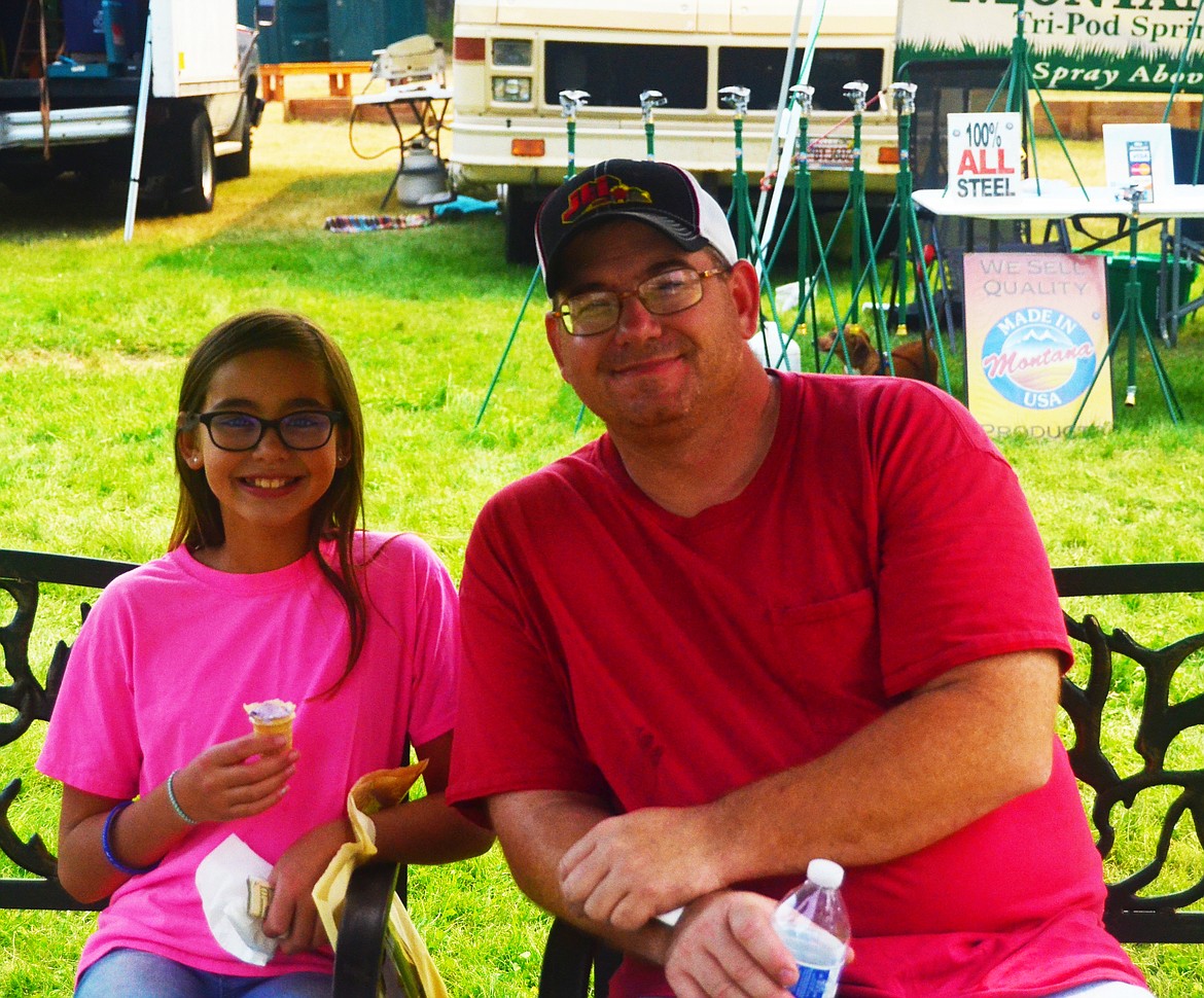 Kate and her dad Brad Hergert cooling down with some ice cream during the festival. Photo Credit Erin Jusseaume Clark Fork Valley Press