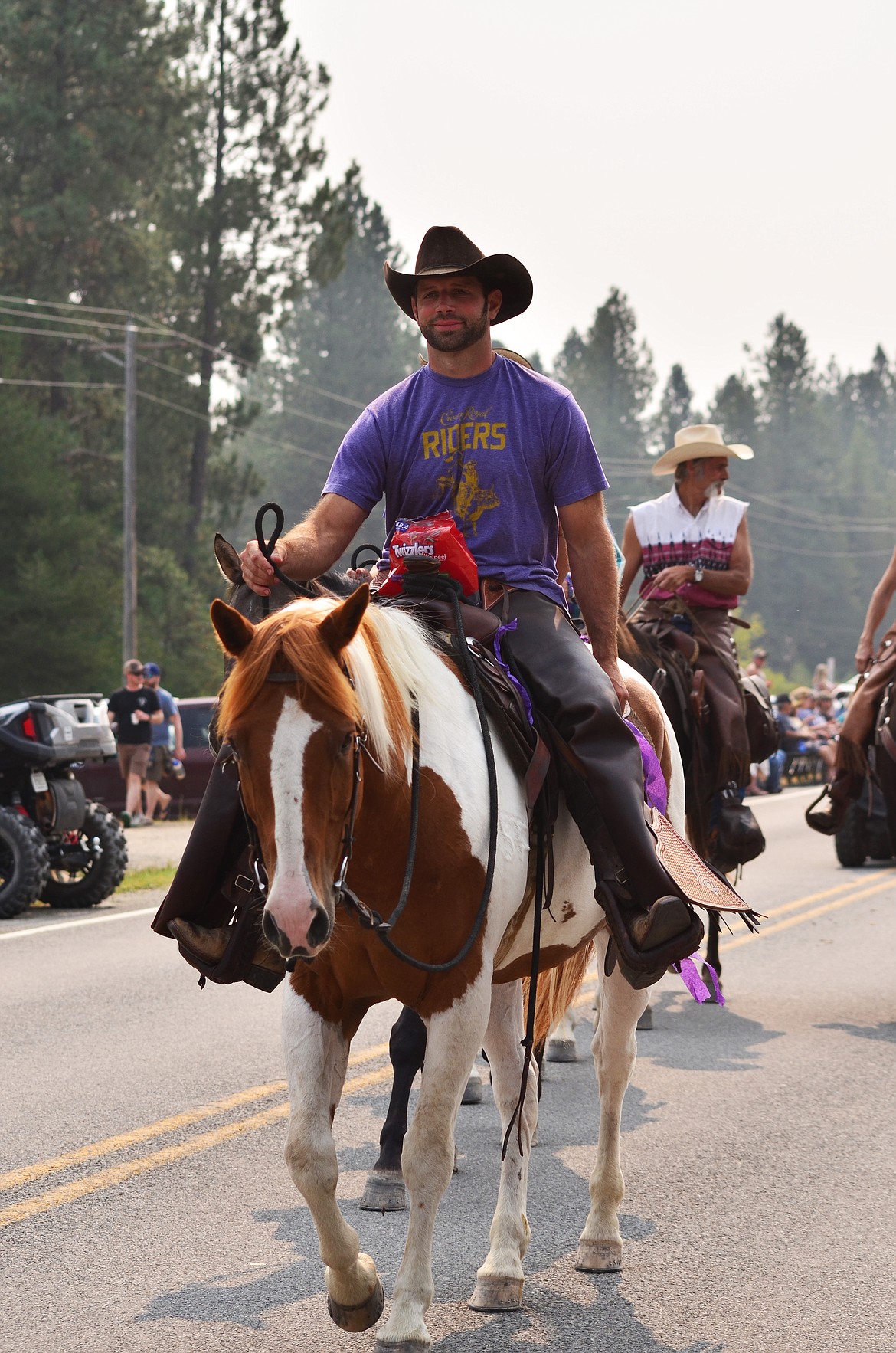 Even the cowboys were seen to have some snacks on the saddle as they walked passed festival goers. Photo Credit Erin Jusseaume Clark Fork Valley Press