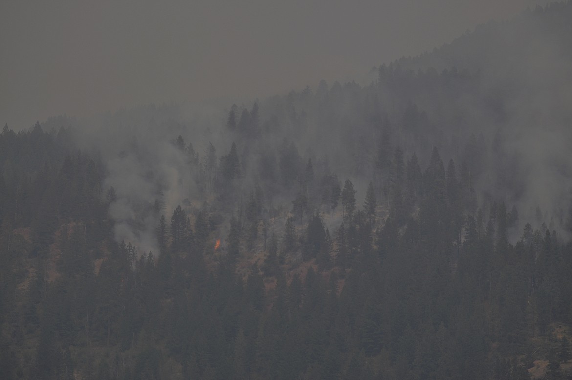 Patches of fire were best seen from Flathead Lake Saturday afternoon as the Blue Bay blaze grew to 38 acres after winds from a weather system caused it to grow.