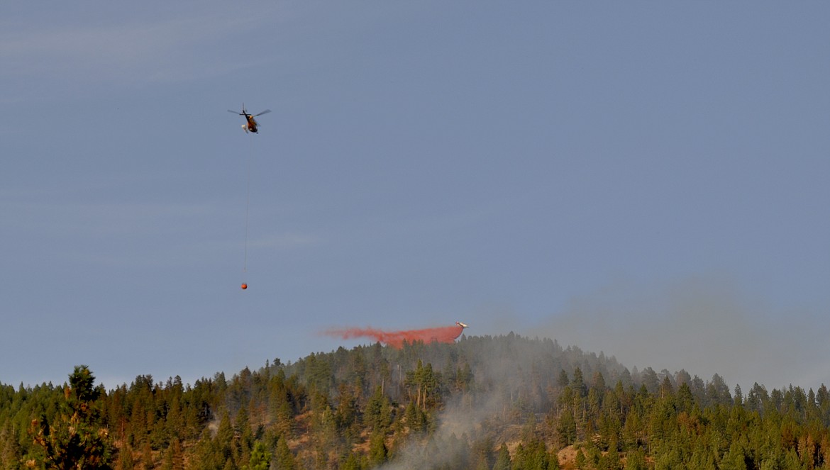 Aircraft worked to contain the Blue Bay #1 fire Monday evening, which was then at about 50 acres. A second fire was at less than an acre and is 100 percent contained, according to officials.