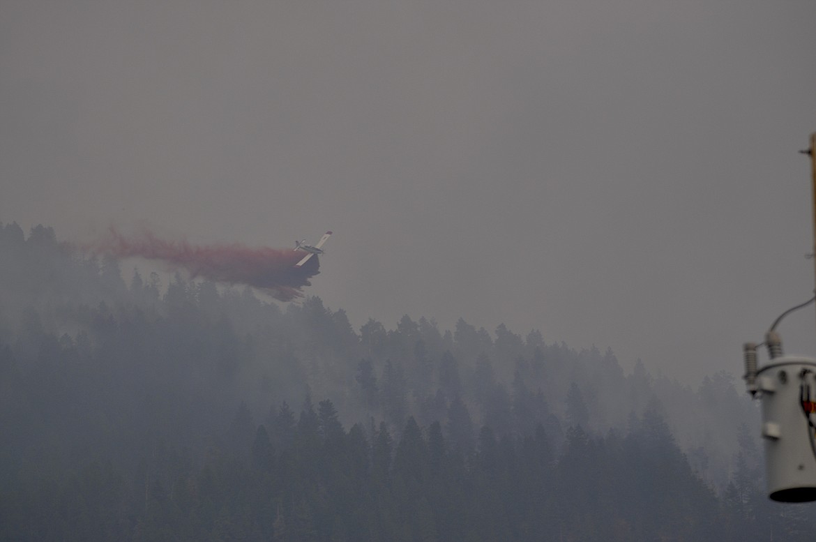 A plane disburses fire retardent at the Blue Bay wildfire Saturday. (PHOTO COURTESY CHRIS KELLY)