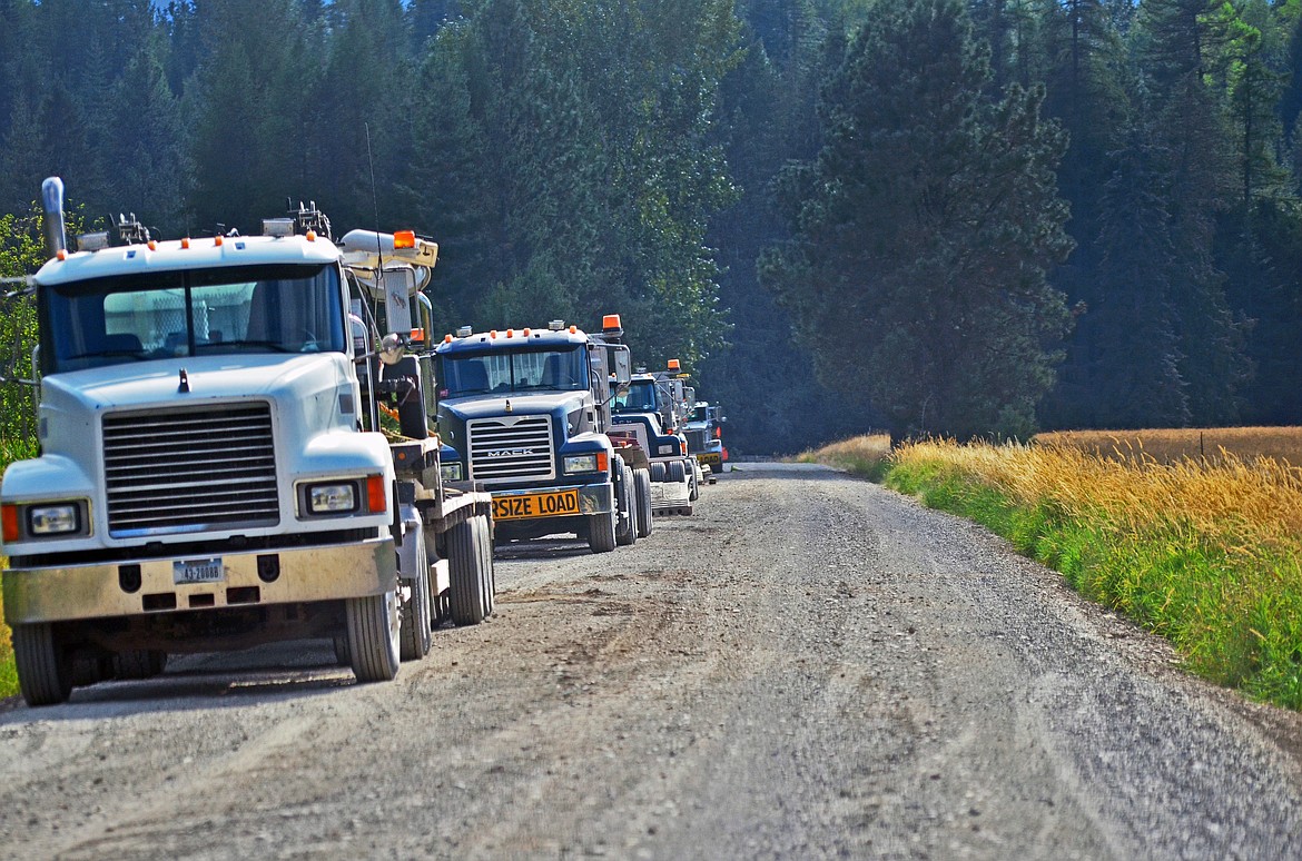 Machinery transport lined up on Lower River Rd at Heron. Photo Credit Erin Jusseaume Clark Fork Valley Press