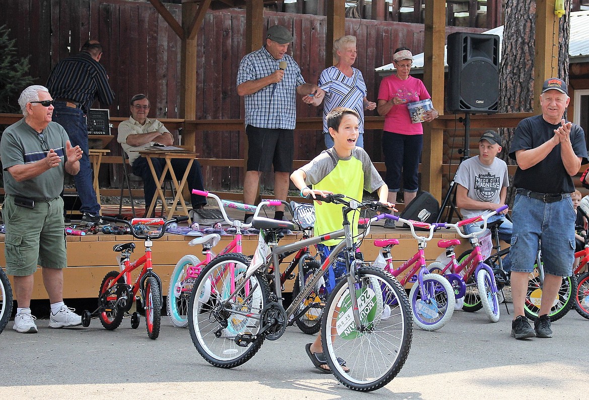 Taylor Callison, 12, from Superior is all smiles after he won a bike during the Living Water Bible Study Group bike raffle on Aug. 5. (Kathleen Woodford/Mineral Independent)