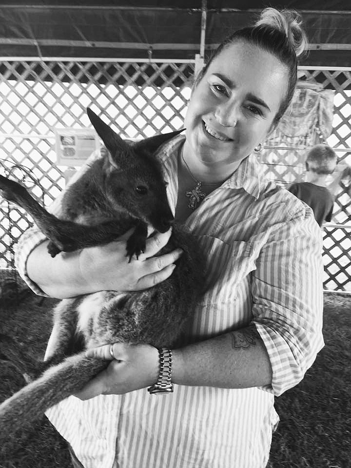 Clark Fork Valley Reporter Erin Jusseaume with a young female Wallaby at the Mineral County Fair. Photo taken by Jeannene Christ owner of the Cute As A Bug Mobile Petting Zoo