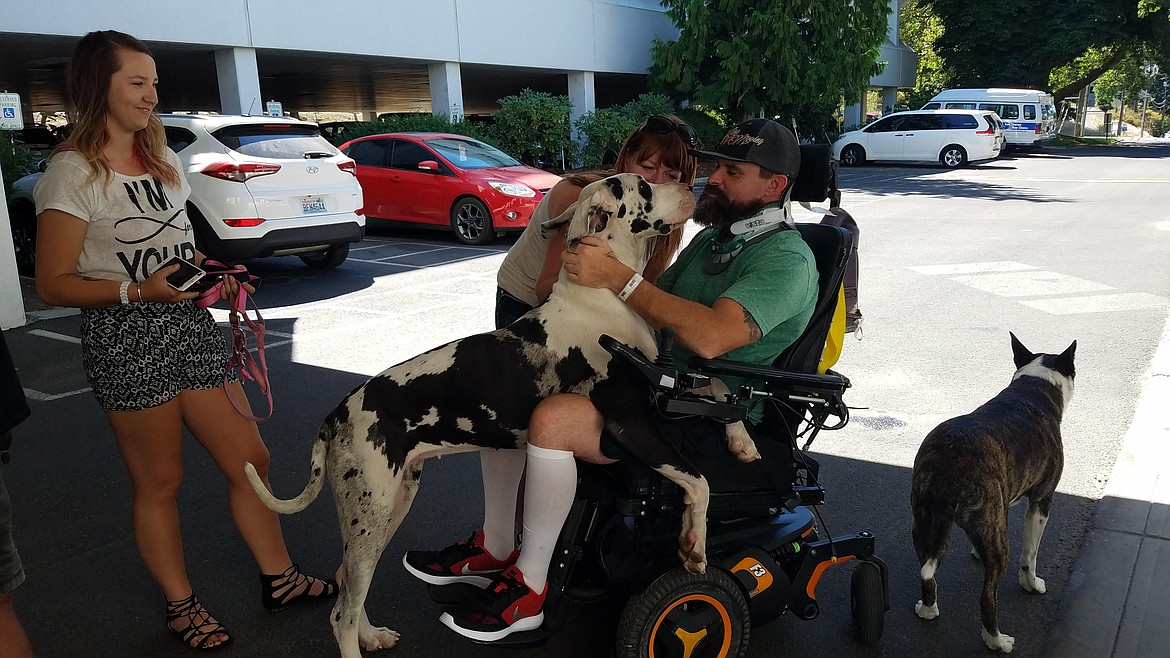 Courtesy photo
Jesse Raymond's great Dane, Leila, shows her human some love during a recent visit to the rehab center where he's staying. Jesse, 43, is paralyzed from the hands down after crushing his spine during a river dive June 29. Pictured also are his daughter, Jasmine, left, fianc&eacute;e Morgan Harryman and his other dog, Roxy.