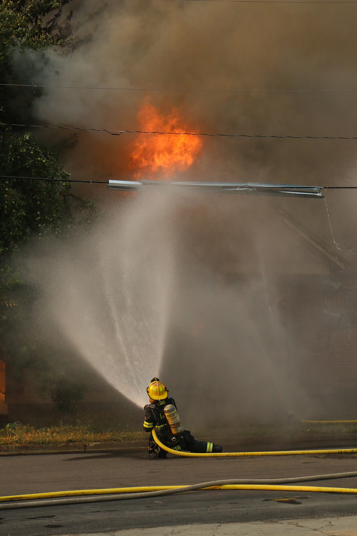 Photo by Mandi Bateman
Bonners Ferry Figherfighter Jacob Porter, keeps the flames at bay.