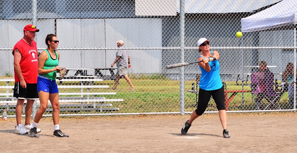 Kim Bergstrom batting, catcher unknown, umpire Jon Zigler. Photo Credit Erin Jusseaume Clark Fork Valley Press