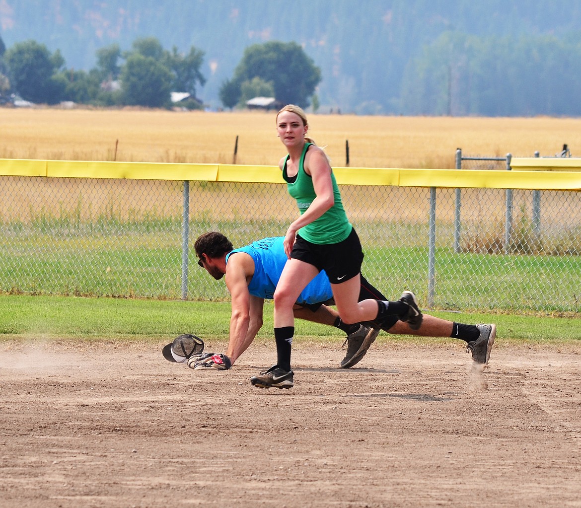 Tanner Ostrom missing the catch as Katie K rounds first base headed for second. Photo Credit Erin Jusseaume Clark Fork Valley Press