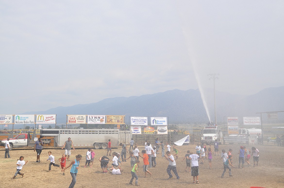 Kids and parents alike cooled down Saturday afternoon as the Ronan Fire Department sprayed everyone with water after participating in activities for the Kiddie/City Slicker Rodeo at Ronan Pioneer Days. (Ashley Fox/Lake County Leader)