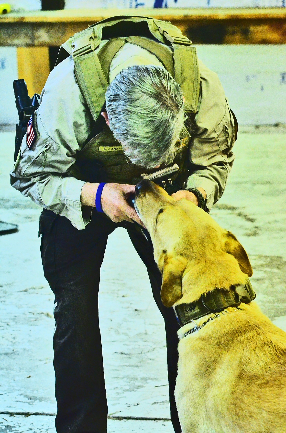 Rewards are important for K-9 Max, and can even become a small game for him to give the toy back for Handler Lynn. Photo Credit Erin Jusseaume Clark Fork Valley Press