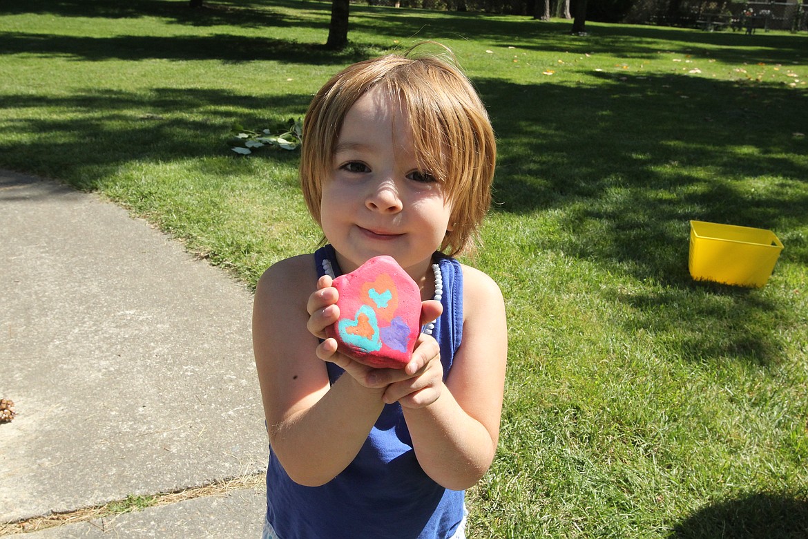 DEVIN HEILMAN/Press
Chloe Vogtsberger, 4, holds up a painted rock Friday near the new Kootenai County Kindness Wall in White Pine Park in Post Falls.