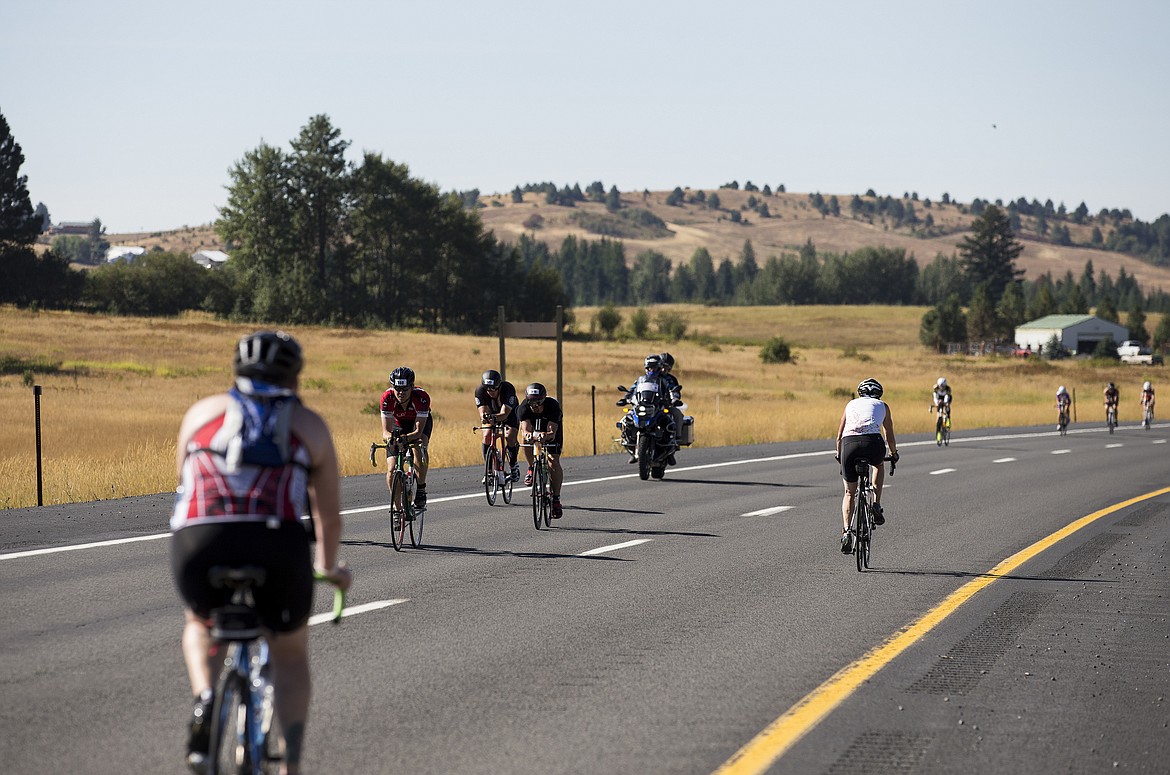 LOREN BENOIT/Press

Athletes cycle near dry summer land south of Coeur d&#146;Alene on U.S. 95 during Ironman Coeur d&#146;Alene on Sunday.